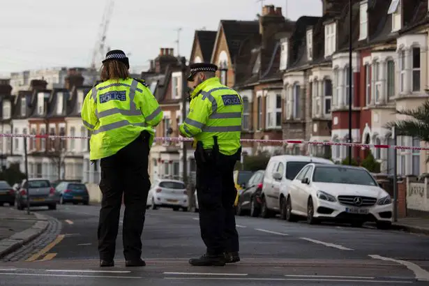 Police guard a crime scene after a fatal stabbing in Tottenham, north London
