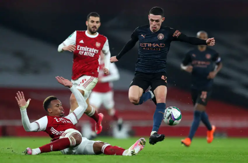LONDON, ENGLAND - DECEMBER 22: Phil Foden of Manchester City is challenged by Gabriel of Arsenal during the Carabao Cup Quarter Final match between Arsenal and Manchester City at Emirates Stadium on December 22, 2020 in London, England. The match will be played without fans, behind closed doors as a Covid-19 precaution. (Photo by Catherine Ivill/Getty Images)