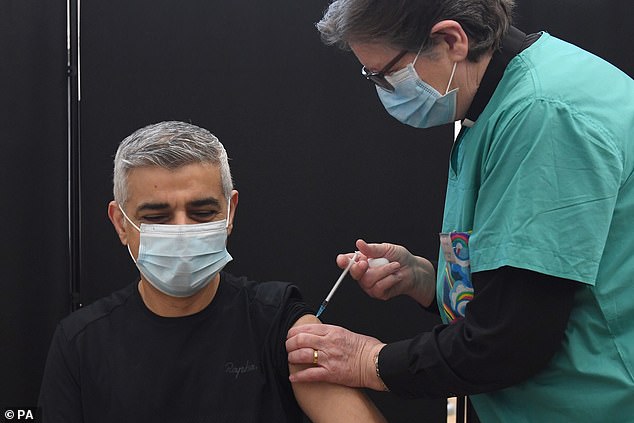 Mayor of London Sadiq Khan receives his first dose of the coronavirus vaccine, administered by Dr Sue Clarke, at Mitcham Lane Baptist Church in South West London this morning