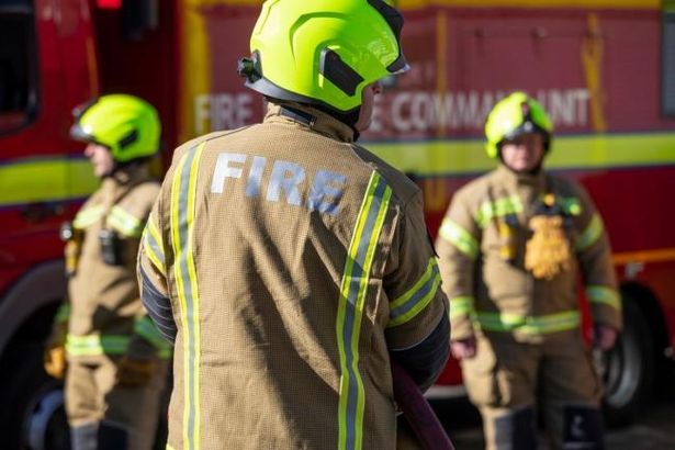 Firefighters wearing breathing apparatus rescued a woman and two children from the top floor of the property