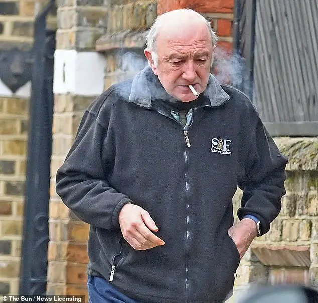 Retired rocker: Former Queen bassist John Deacon looked worlds away from his rocker days as he enjoyed a low-key stroll while puffing on a cigarette near his south-west London home